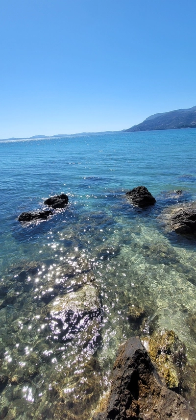 Panoramic view of Corfu from Ksamil Beach, Albania with crystal-clear waters